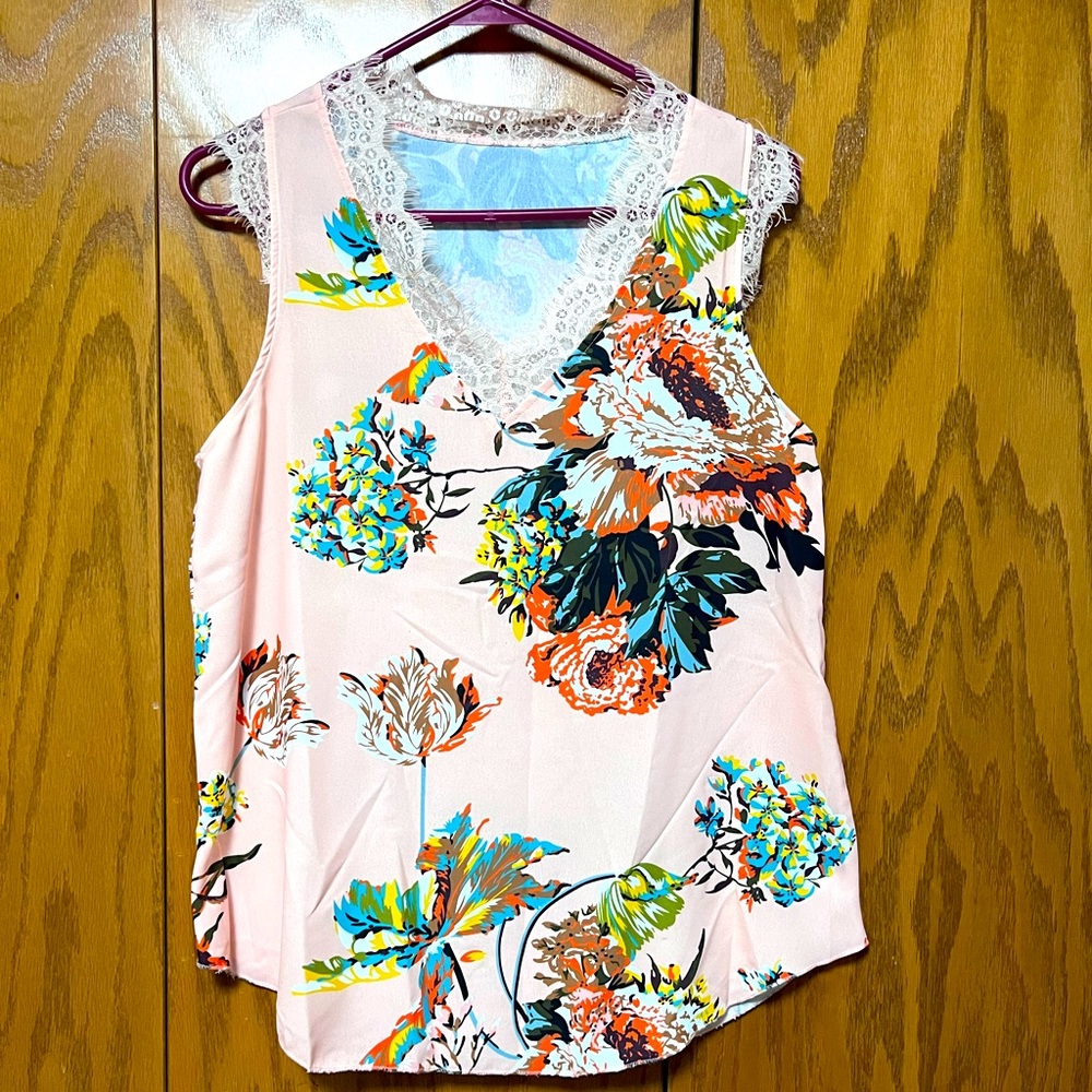 Camisole with lace lined neck and floral pattern.